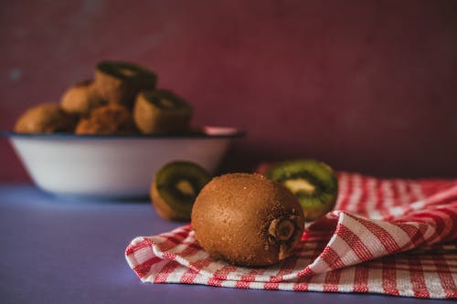 Kiwi Fruits Lying on a Striped Dish Towel