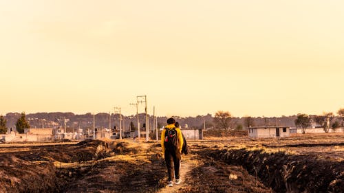 People Walking on Footpath in Village