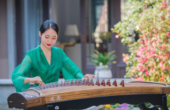 Photo of a Young Woman Playing Guzheng