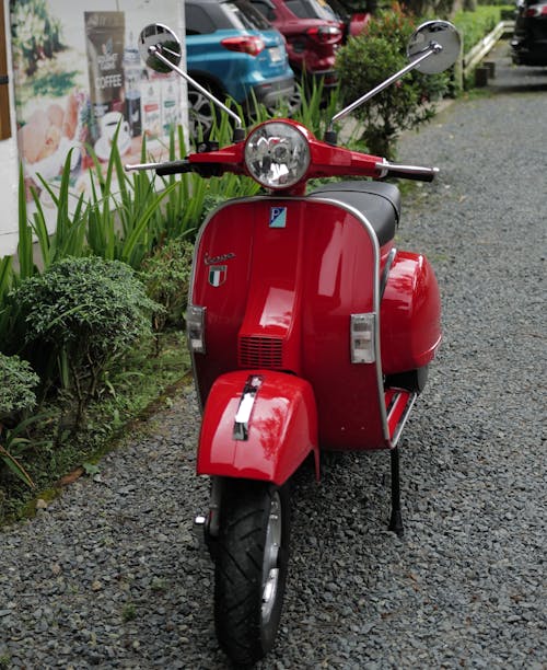 Red Moped Standing Outdoors