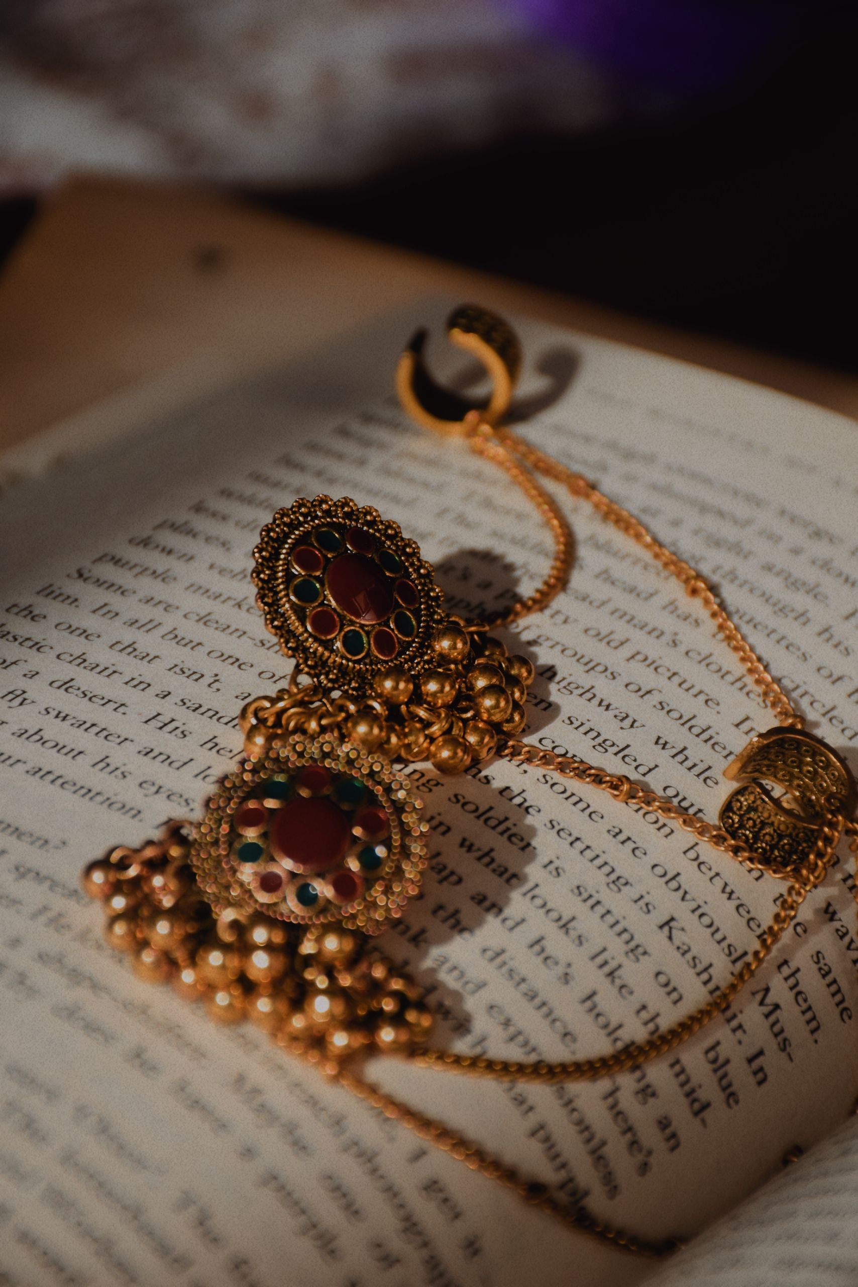 Golden earrings resting on an open book