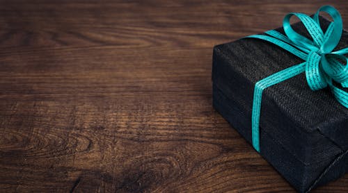 Black Gift Box on Wooden Surface