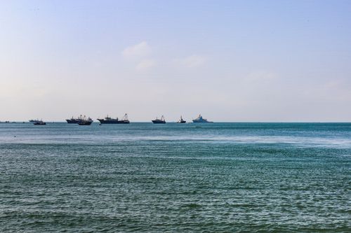 Free A serene ocean view with multiple boats on the horizon under a clear sky, ideal for transportation and travel themes. Stock Photo