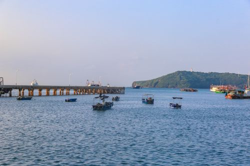 Free Serene coastal scene depicting moored boats and pier under a clear blue sky. Stock Photo