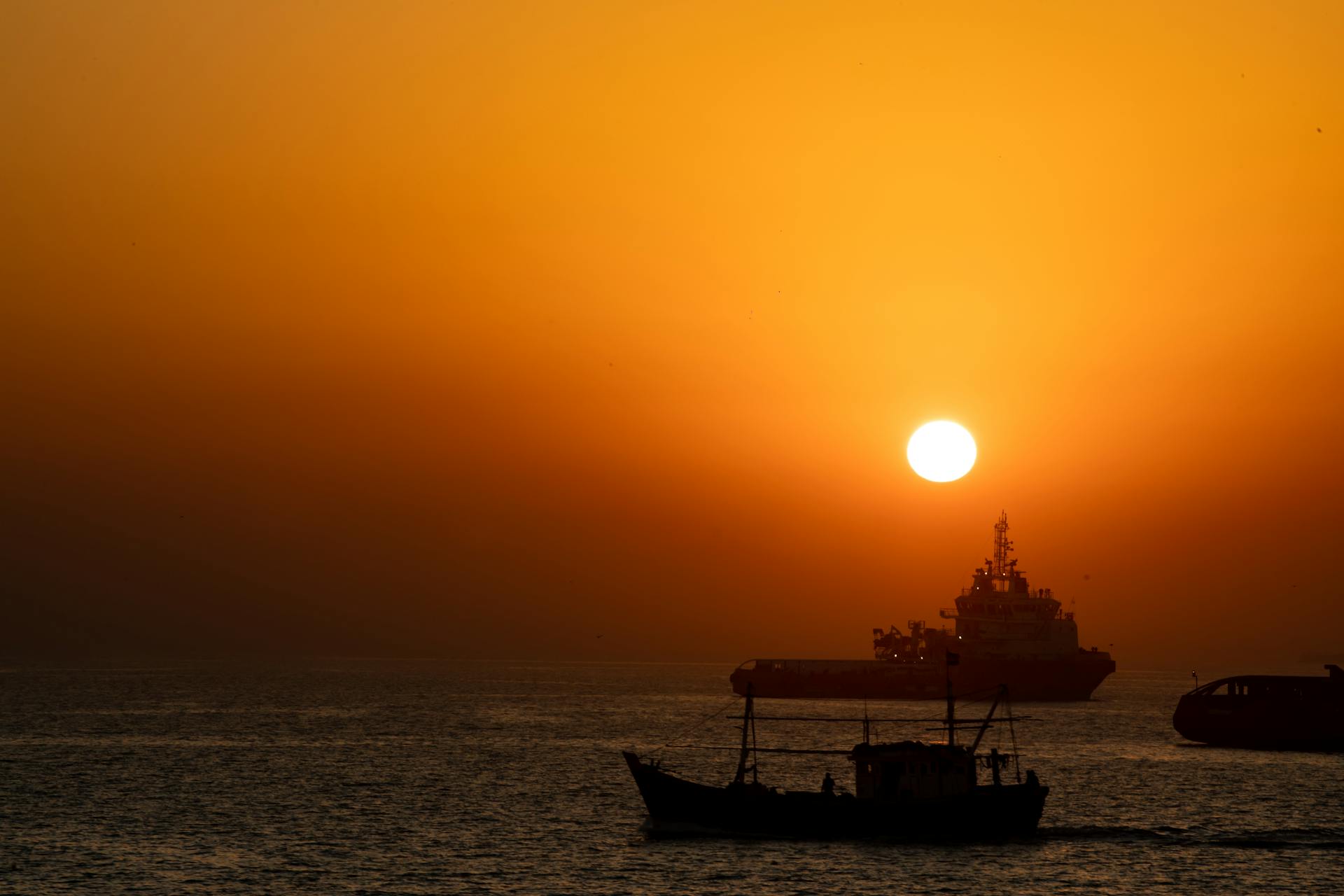 Yellow Sky and Sun over Vessels at Sunset