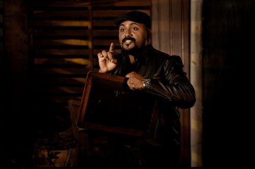 Free Portrait of a man in a leather jacket making a gesture indoors. Stock Photo