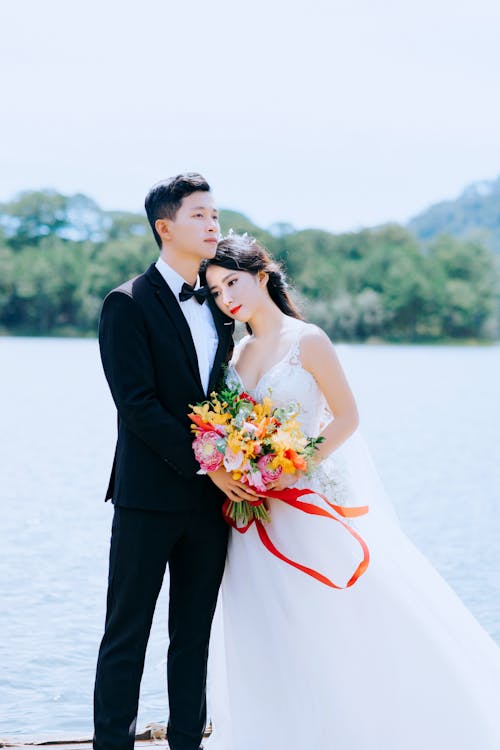 Photo of Couple Standing Near Body Of Water