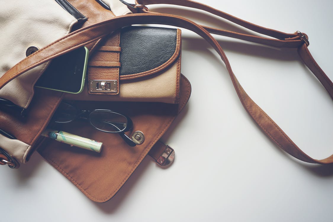 Free Brown Leather Crossbody Bag With Eyeglasses Stock Photo
