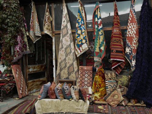 Free Vibrant Turkish rugs and textiles on display in an Ankara bazaar, showcasing rich patterns and craftsmanship. Stock Photo