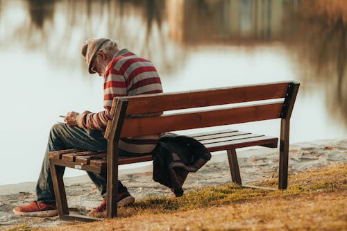 Elderly Man Sitting on a Bench 