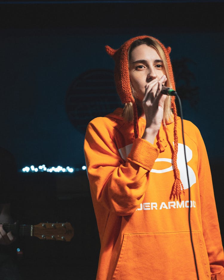 Woman In A Sweatshirt Performing On Stage 