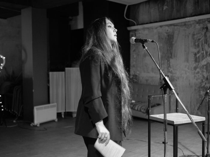 Nightbloom Sessions poster — spoken-word performer at a microphone, photo by Viktorya Sergeeva on Pexels