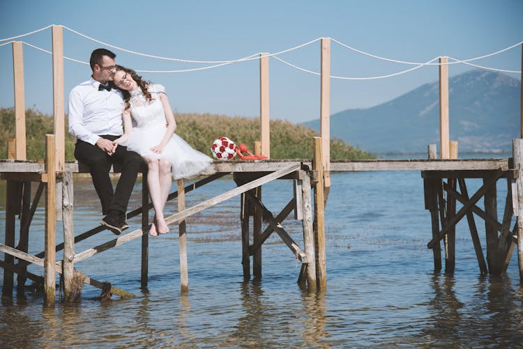 Photo Of Couple Sitting On Dock