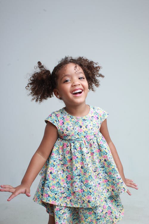 Portrait of a Little Girl in a Dress with a Floral Pattern 