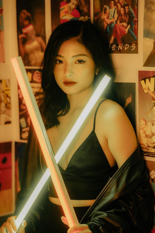 Woman Holding Two Light Sabers 
