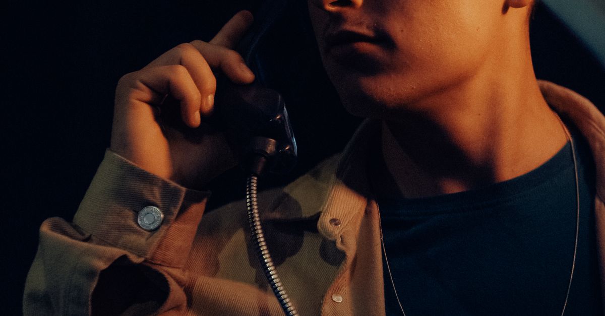 Young Man Using a Payphone · Free Stock Photo