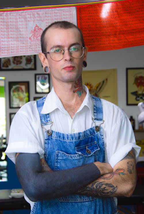 Man in Overalls and Tattooed Arms 