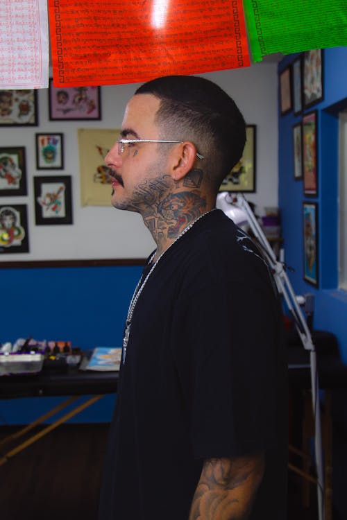 Man in Eyeglasses and with Tattoo