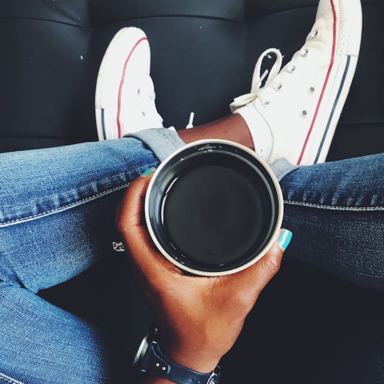 Top View Photo Of Person Holding Cup