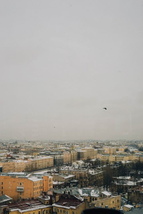 Free Aerial view of a snow-covered cityscape during winter, showcasing historic urban architecture. Stock Photo