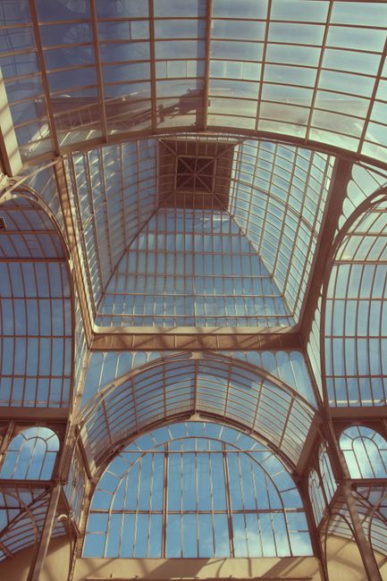 A stunning view of modern glass ceilings and arches creating a symmetrical pattern.