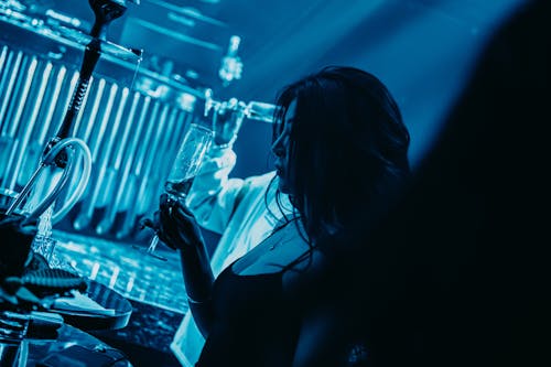 Woman Having a Drink in a Nightclub 