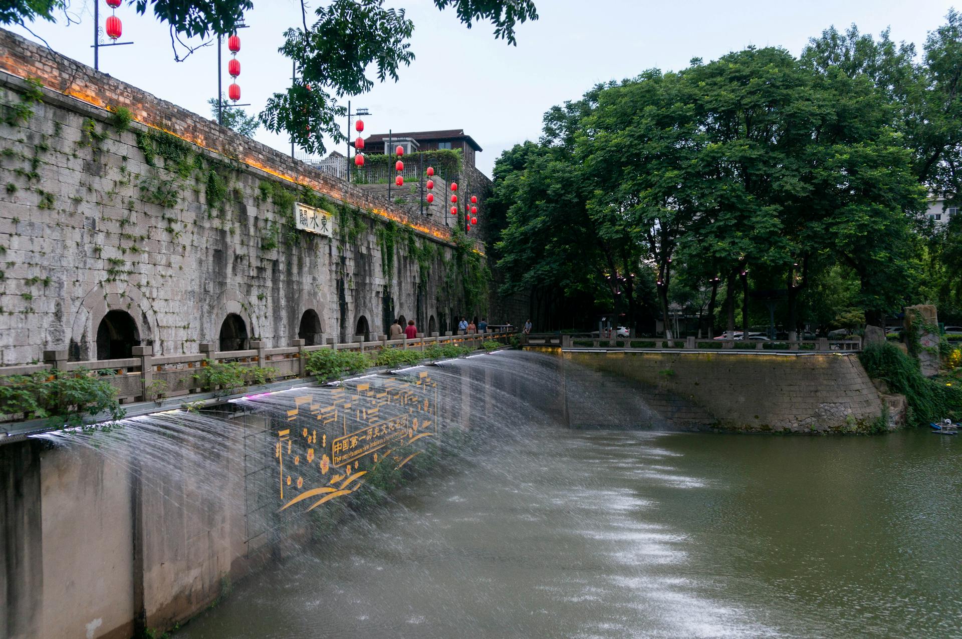 A stunning blend of ancient architecture and nature with a Chinese bridge.