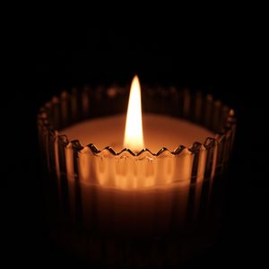 Candle burning in a dim room — photo by Vind on Pexels