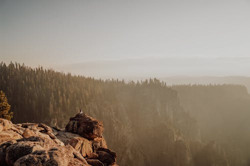 Hiker on the Rock in the Mountains Admiring the Sunrise