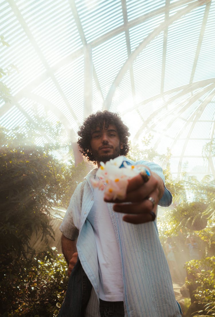 Man Posing In Greenhouse