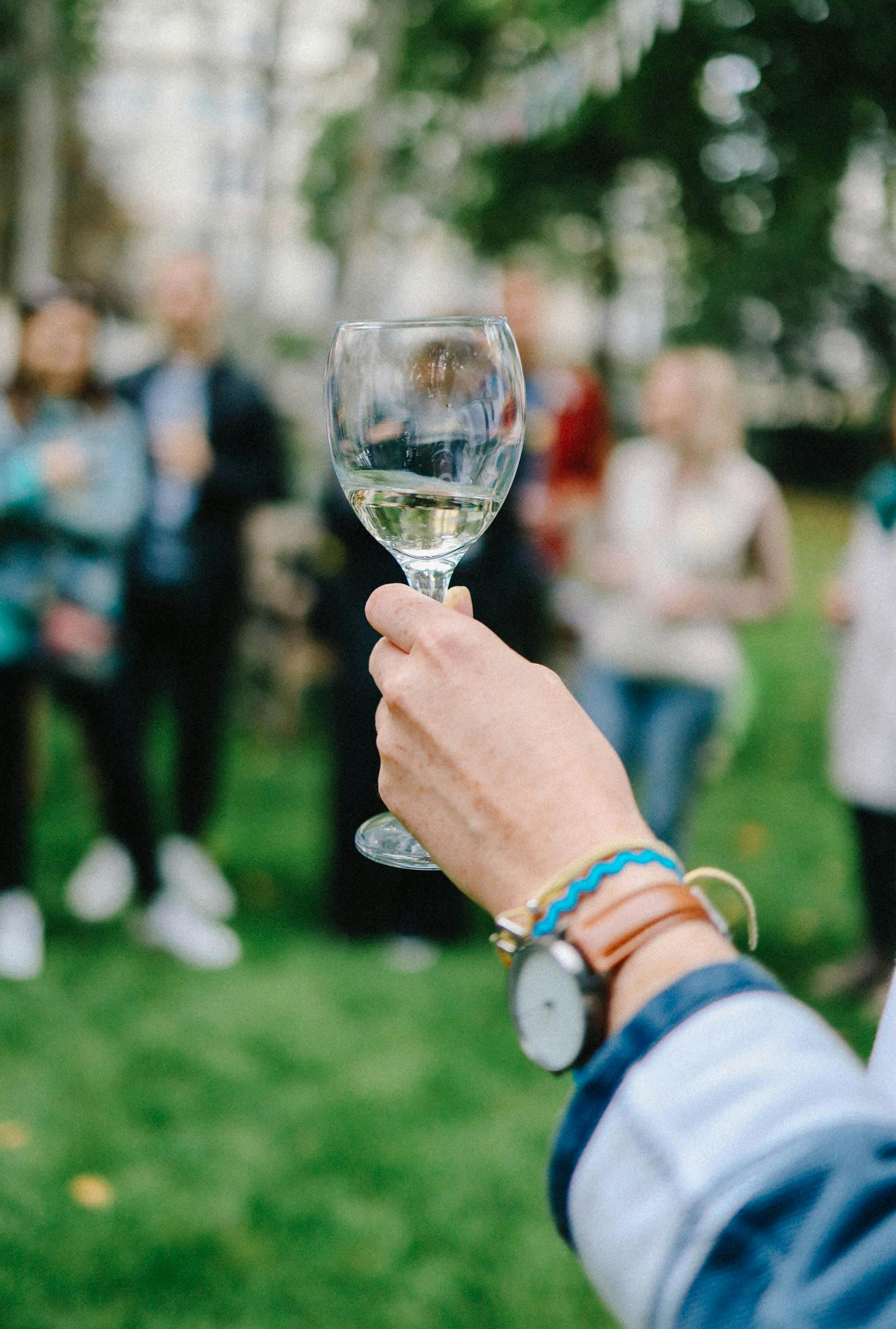 hand holding glass with alcohol