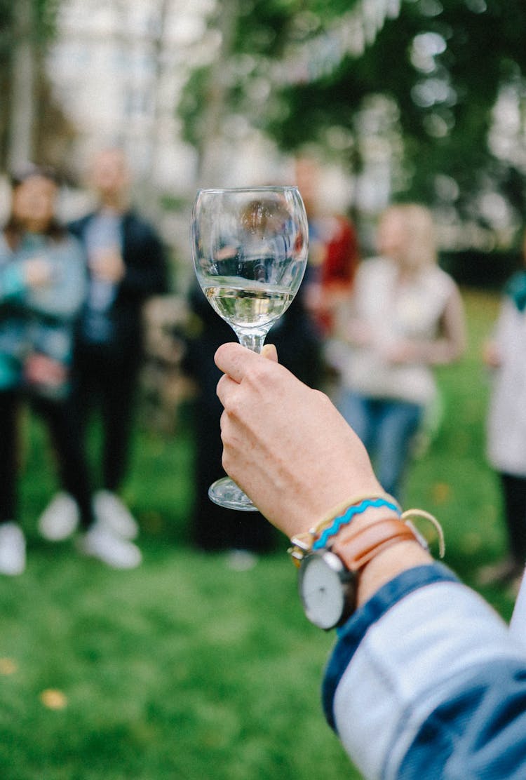 Hand Holding Glass With Alcohol