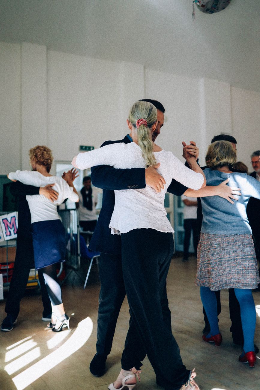 Adults practicing ballroom dancing while easing first dance class nerves