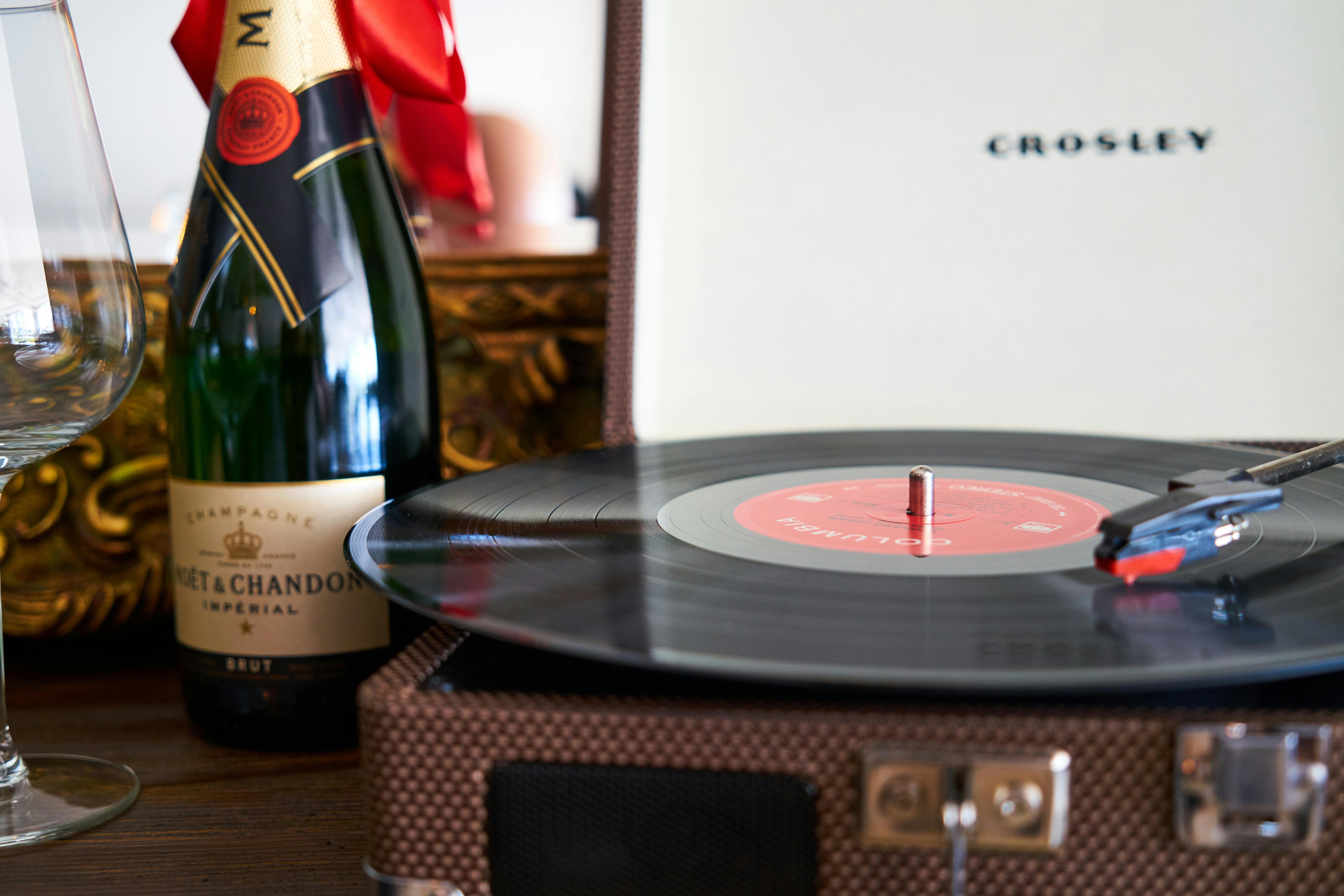 black turntable beside liquor bottle