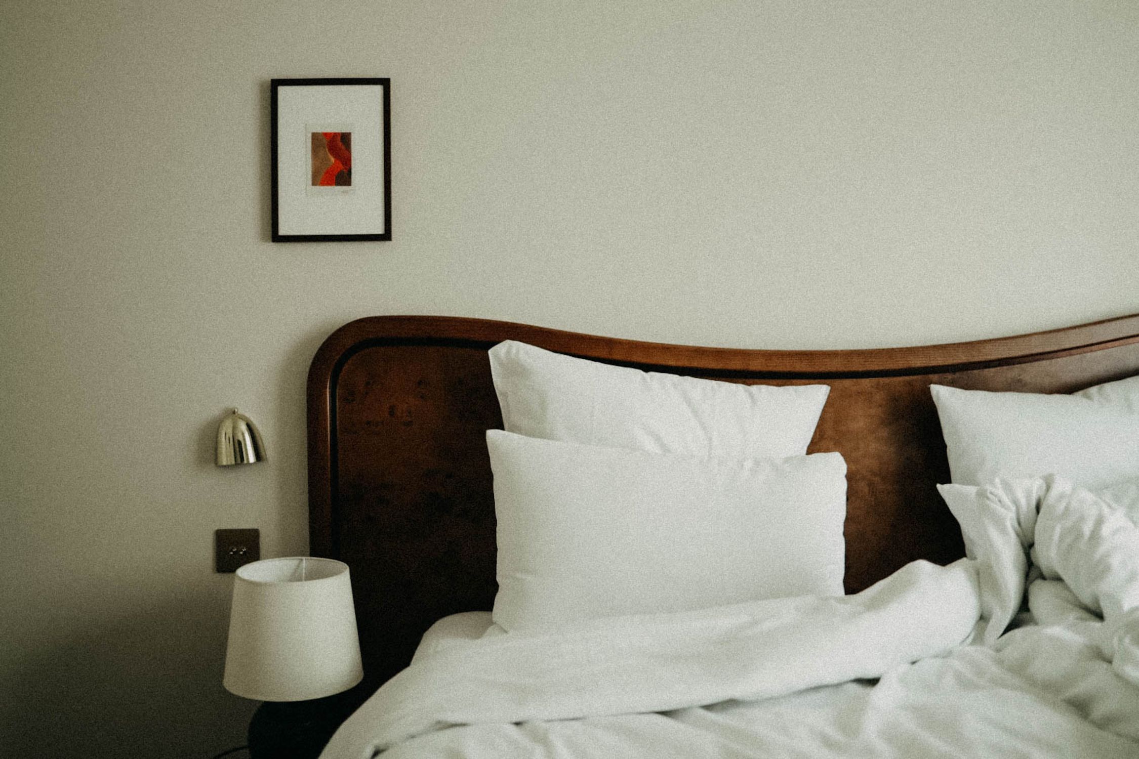 Chic bedroom featuring modern decor with plush pillows and a stylish headboard.