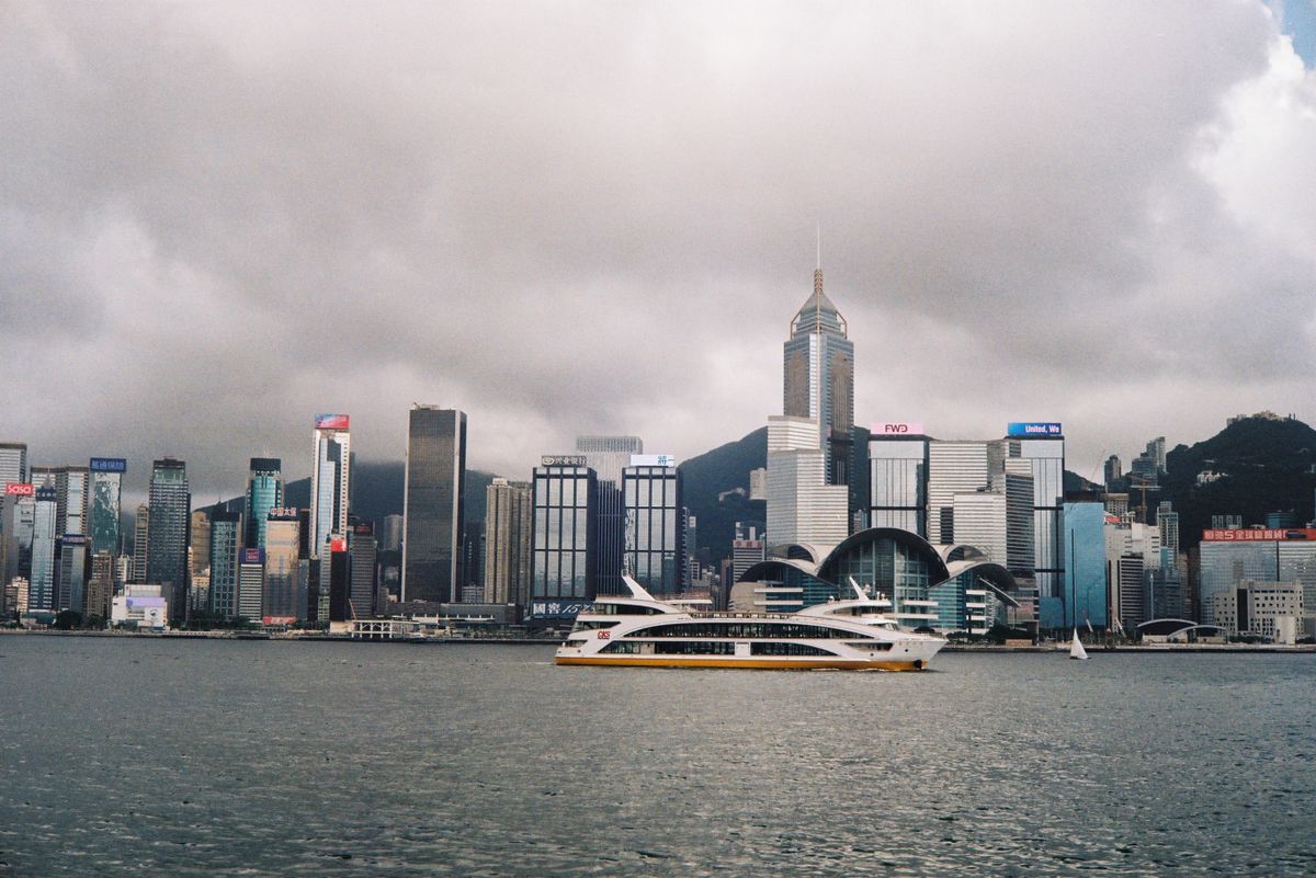 Victoria Harbour with a passing ferry, Hong Kong skyline in the background