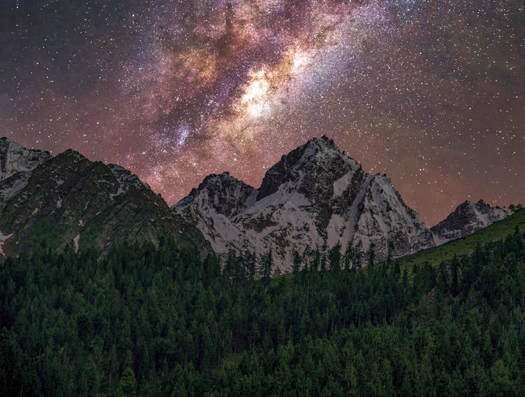 Stars And Milky Way Over Mountains And Forest At Night