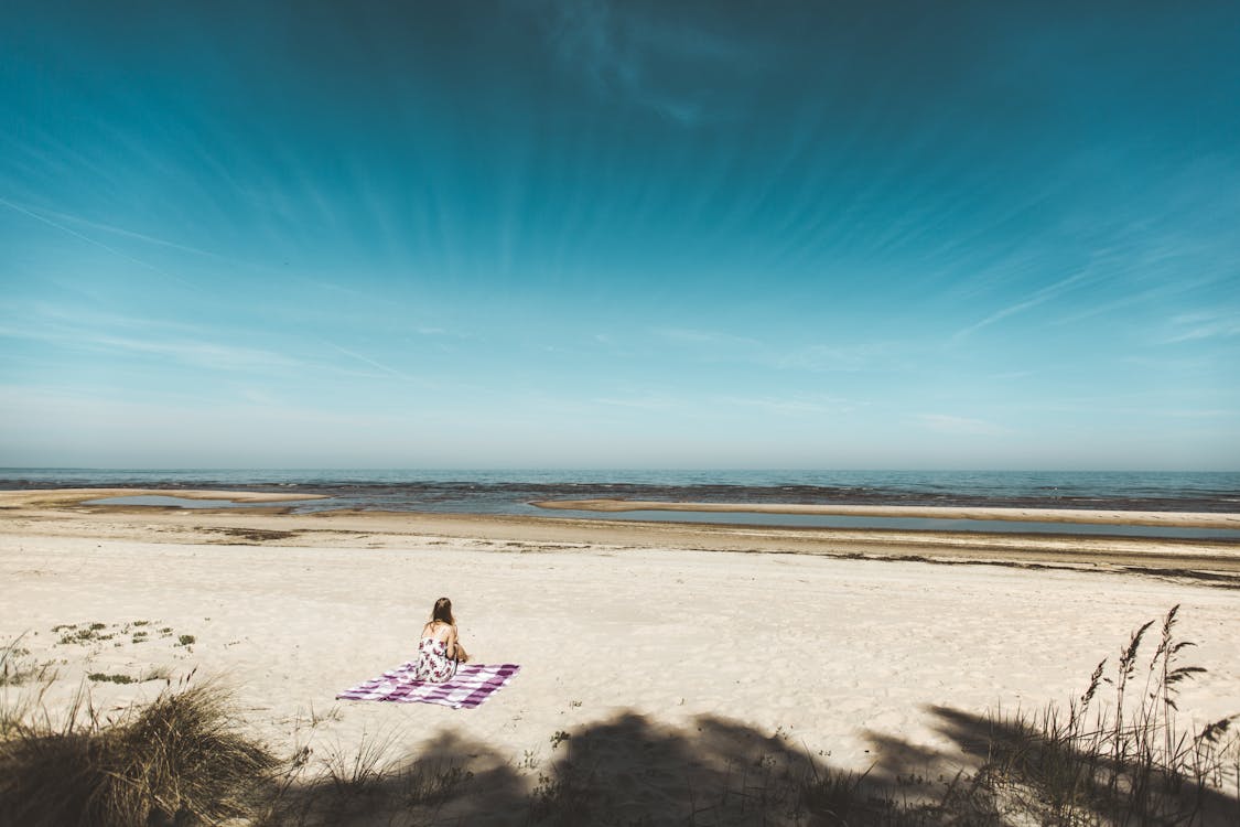 Woman Sitting on Seashore