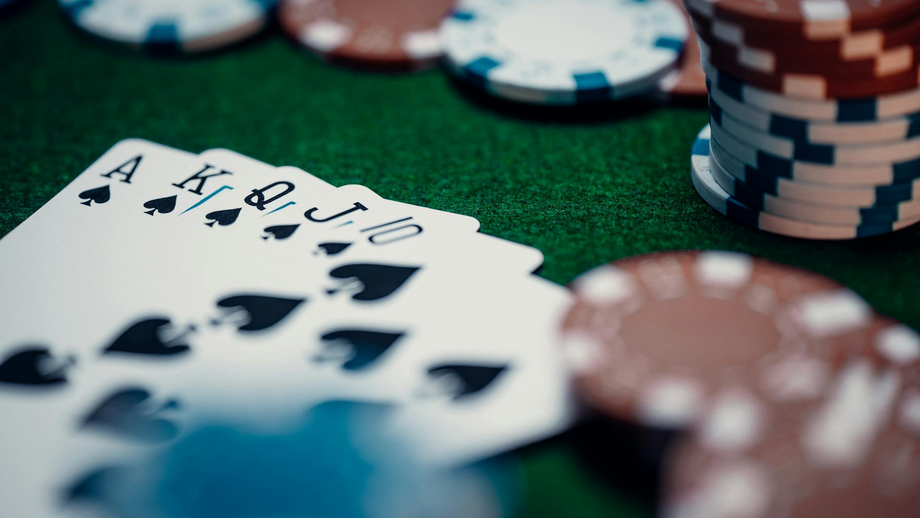 5 Reward Credit Cards That Make Spending Enjoyable in 2024 5 Close-up of a royal flush poker hand surrounded by colorful chips on a green table.