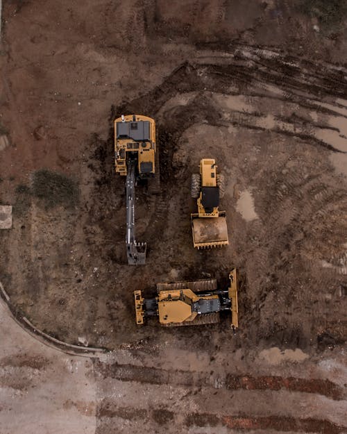 Free Aerial Photo Of Excavator, Road Roller, And Bulldozer Stock Photo