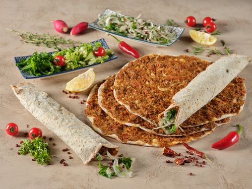 Free A tempting spread of Turkish lahmacun served with fresh vegetables and herbs. Stock Photo