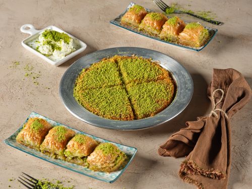 Free A selection of traditional Turkish desserts, including baklava and kunafa, garnished with pistachios. Stock Photo