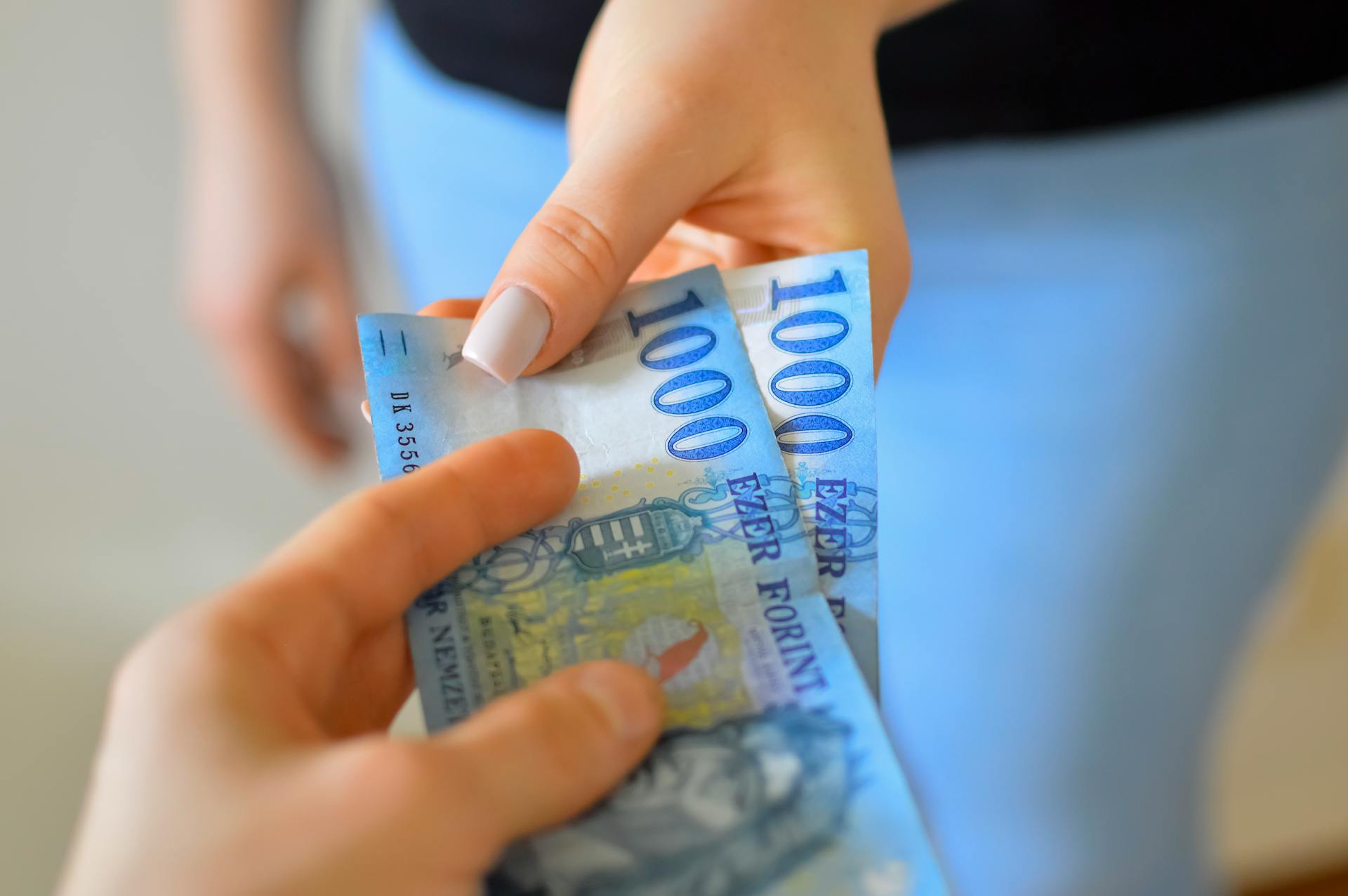 Closeup of Hands Holding Banknotes