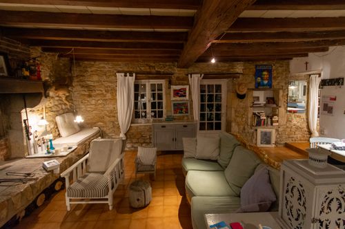 Rustic living room with stone walls and wooden beams — photo by Jan van der Wolf on Pexels
