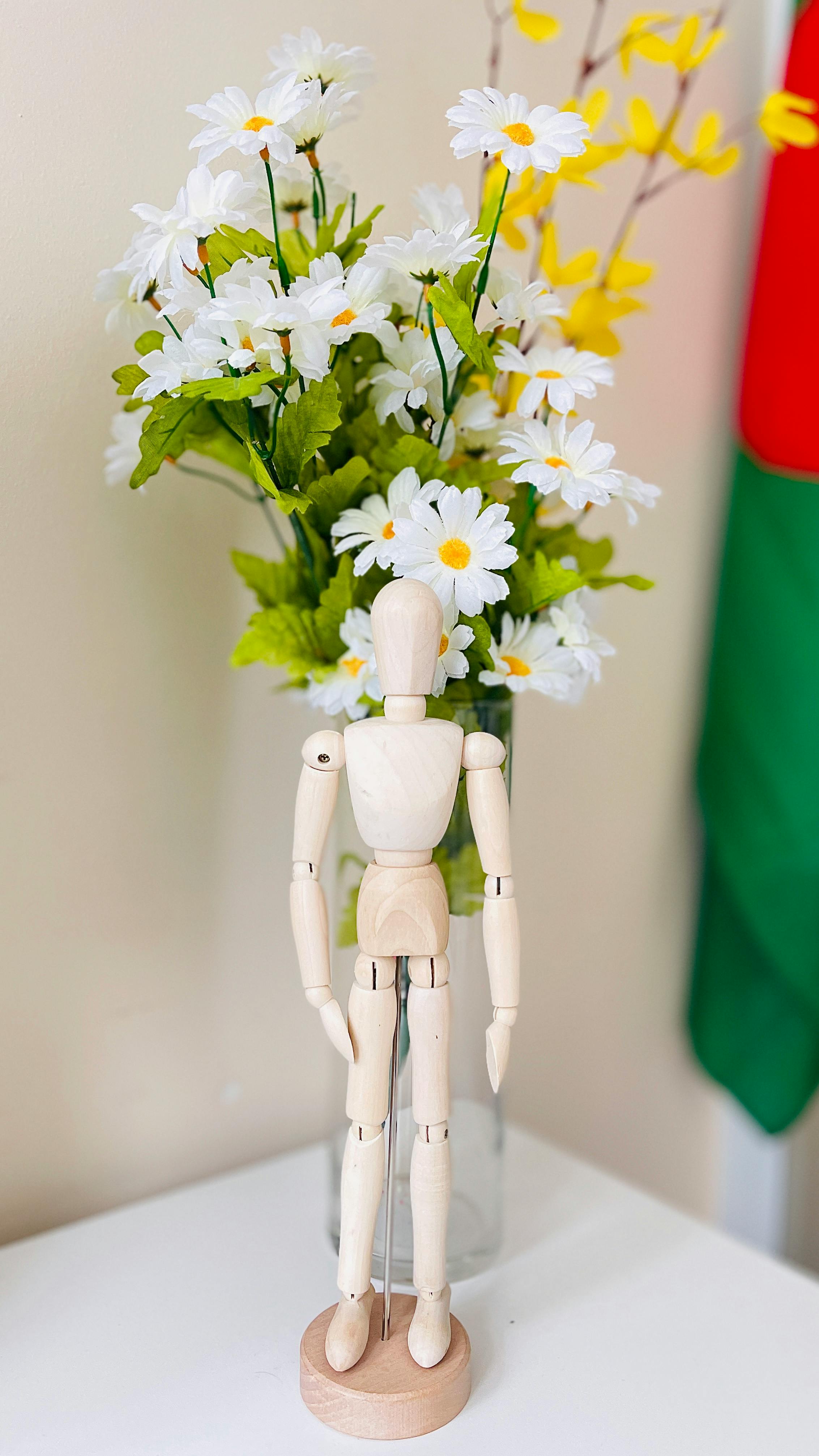 wooden doll and flowers