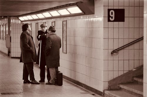 Elegant Men in a Metro Station in Sepia 