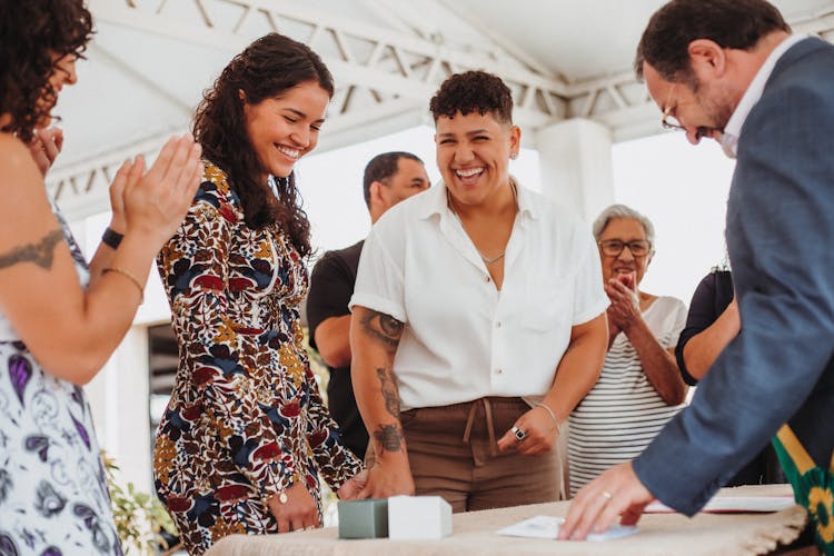 Laughing Women With People By Table