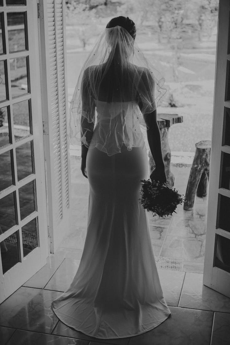 Woman In Wedding Dress In Door