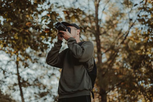 Man Taking Pictures in a Forest 