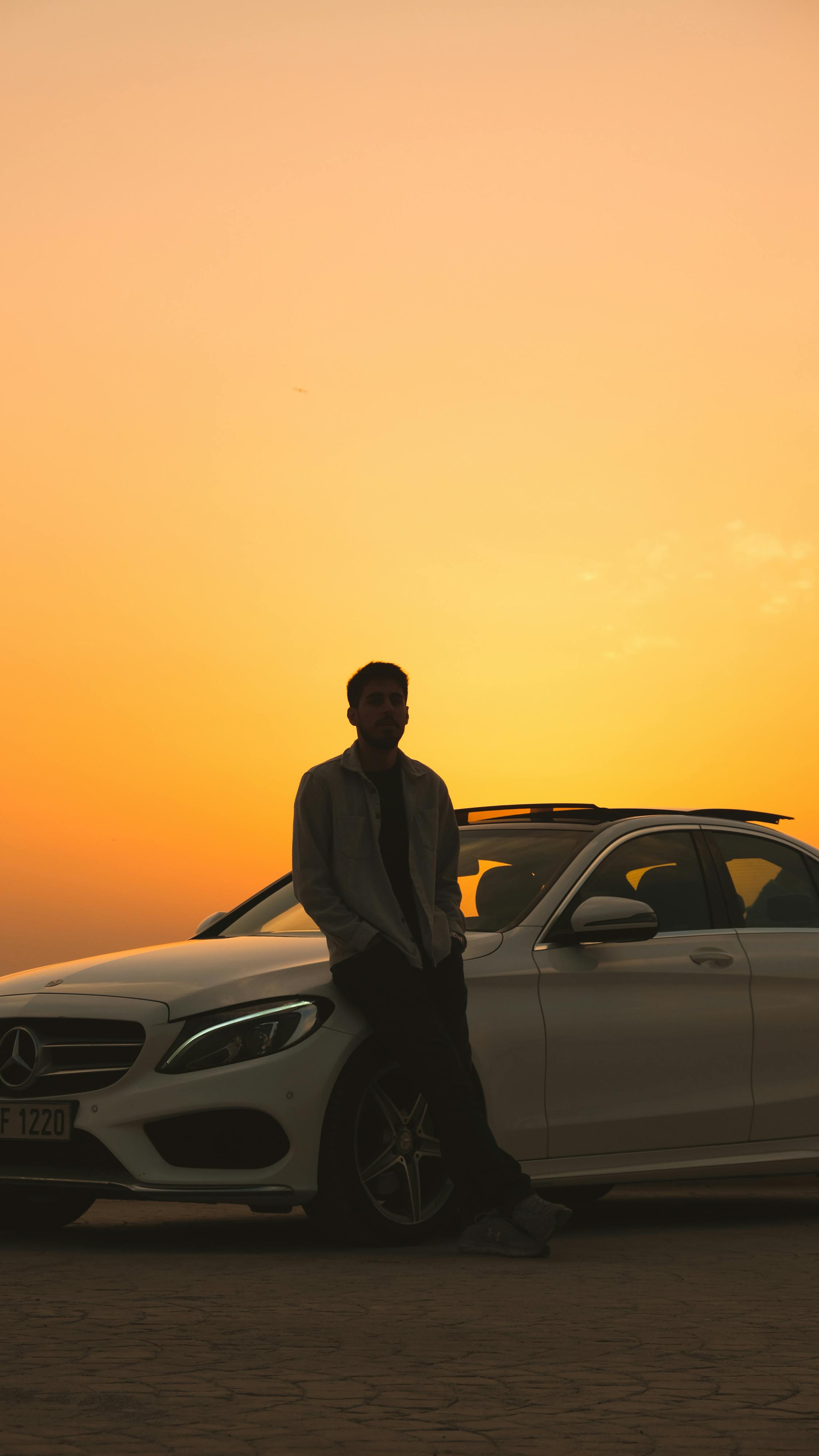Man Standing by Car at Sunset · Free Stock Photo